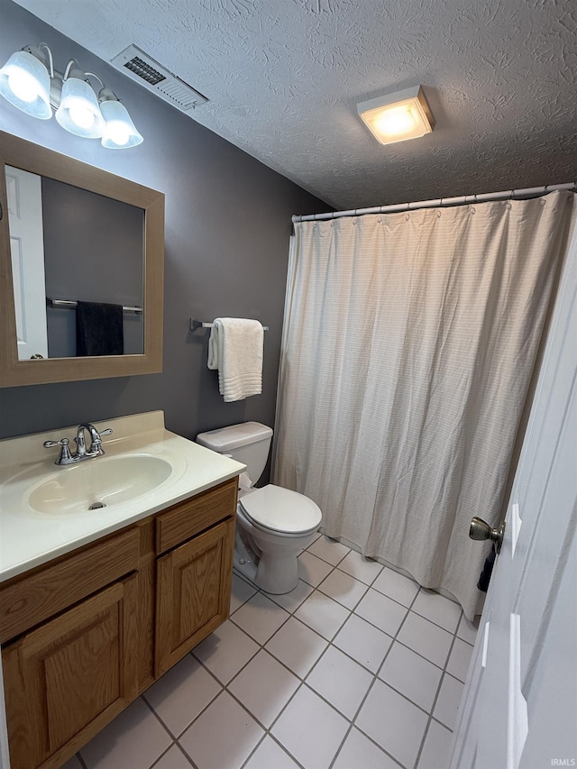 9607 S Lake Ridge Dr, Bloomington, IN 47401 - full bathroom with tile patterned flooring, vanity, toilet, and a textured ceiling