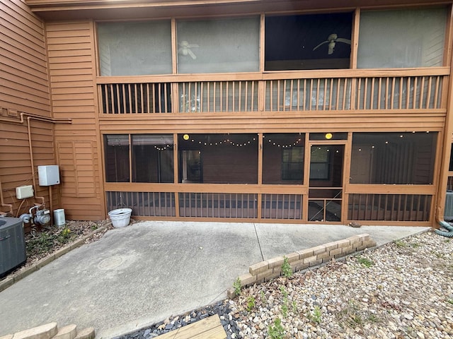 9607 S Lake Ridge Dr, Bloomington, IN 47401 - back of property with a sunroom, a patio area, and central AC