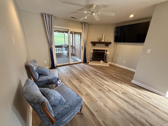 9607 S Lake Ridge Dr, Bloomington, IN 47401 - living area with baseboards, ceiling fan, wood finished floors, recessed lighting, and a textured ceiling