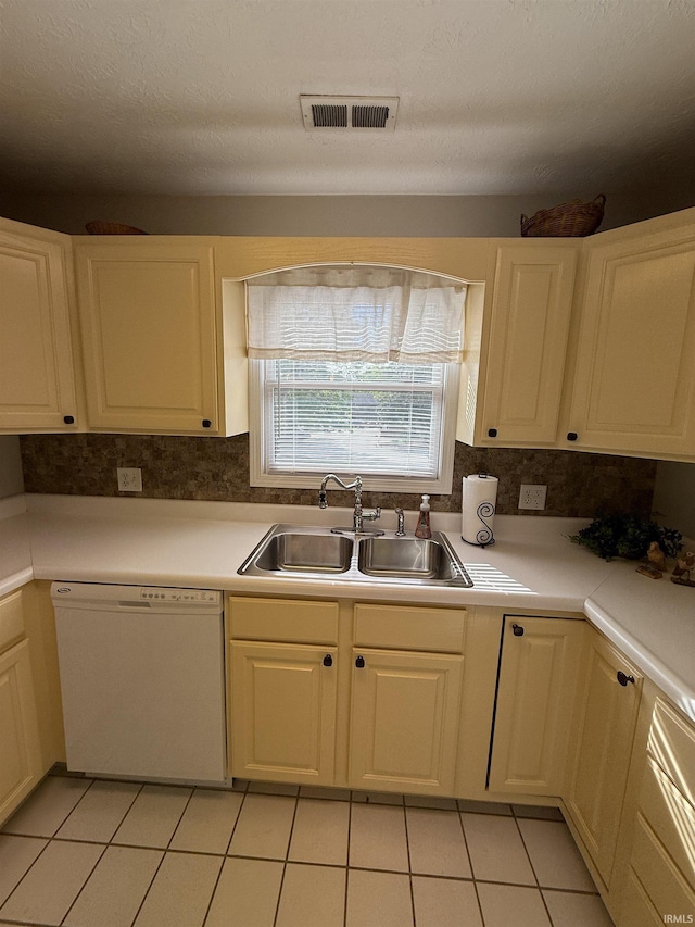 9607 S Lake Ridge Dr, Bloomington, IN 47401 - kitchen featuring white dishwasher, a sink, light tile patterned flooring, white cabinets, and decorative backsplash