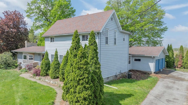 view of home's exterior featuring a yard and a garage