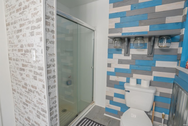 full bathroom with a stall shower, toilet, and wooden walls