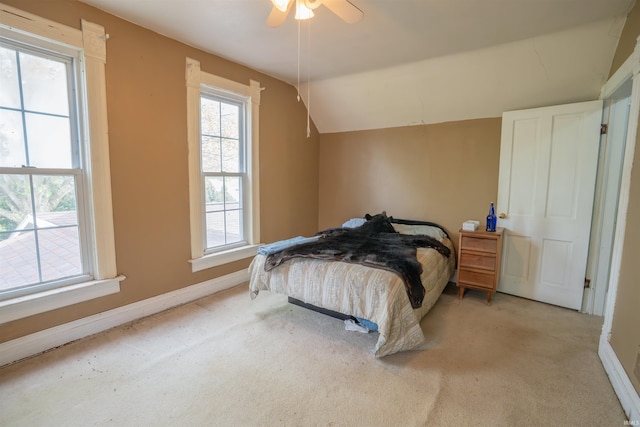 bedroom with carpet, lofted ceiling, baseboards, and ceiling fan