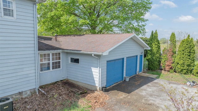 detached garage featuring central air condition unit