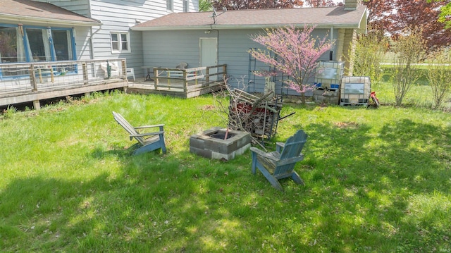 view of grassy yard with a wooden deck