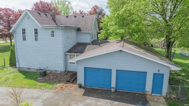 view of property exterior with a garage and roof with shingles