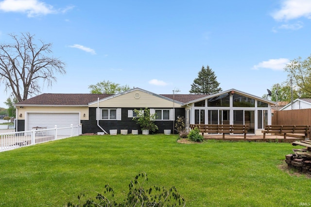 view of front of house with an attached garage and a sunroom