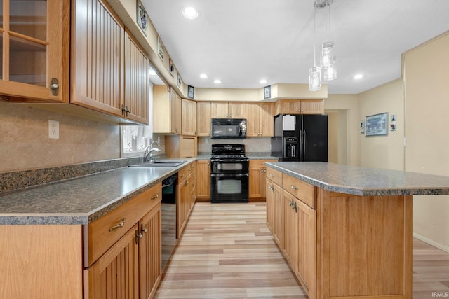 kitchen with black appliances, a sink, light wood finished floors, recessed lighting, and a center island