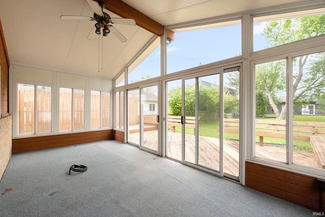 unfurnished sunroom with carpet floors, ceiling fan, beamed ceiling, and high vaulted ceiling