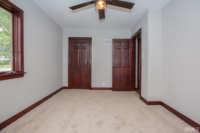 6318 Peacock Ln, Evansville, IN 47715 - empty room featuring light colored carpet, ceiling fan, and baseboards