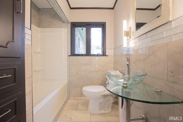 6318 Peacock Ln, Evansville, IN 47715 - full bath featuring tile walls, marble look tile flooring, ornamental molding, toilet, and a sink