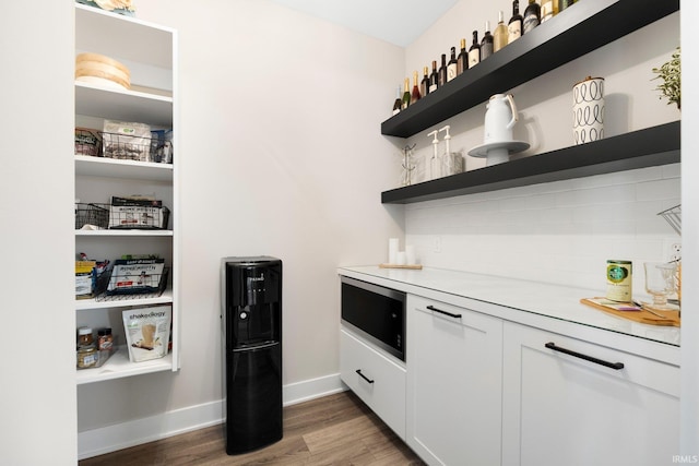 874 Cascata Trl, Huntertown, IN 46748 - indoor dry bar with light wood-style floors, baseboards, and built in microwave