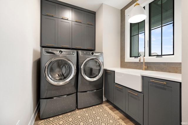874 Cascata Trl, Huntertown, IN 46748 - laundry area with cabinet space, washer and clothes dryer, and light wood-type flooring