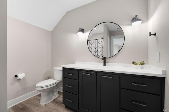 874 Cascata Trl, Huntertown, IN 46748 - bathroom featuring wood finished floors, toilet, lofted ceiling, baseboards, and vanity