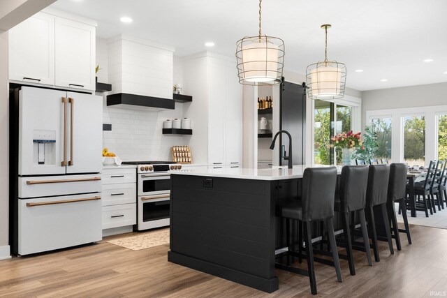 874 Cascata Trl, Huntertown, IN 46748 - kitchen featuring white refrigerator with ice dispenser, range with two ovens, open shelves, light countertops, and tasteful backsplash