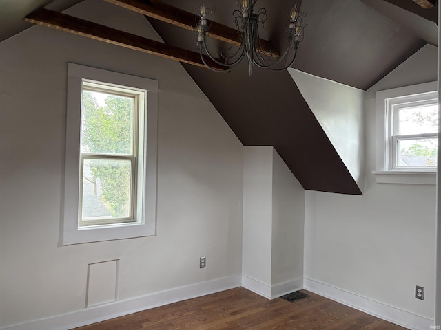 bonus room featuring lofted ceiling, dark wood-style flooring, a chandelier, and baseboards