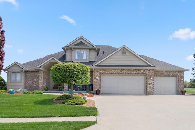 3090 Kellygreen Dr, Angola, IN 46703 - view of front facade with driveway, a garage, a front lawn, brick siding, and roof with shingles