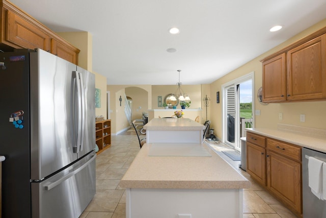 3090 Kellygreen Dr, Angola, IN 46703 - kitchen with appliances with stainless steel finishes, a kitchen island, arched walkways, light countertops, and recessed lighting