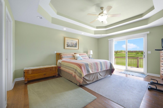 3090 Kellygreen Dr, Angola, IN 46703 - bedroom with a raised ceiling, access to exterior, a ceiling fan, wood finished floors, and baseboards