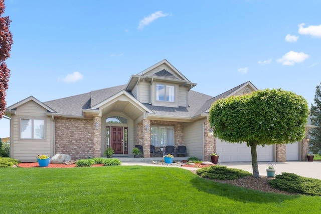 3090 Kellygreen Dr, Angola, IN 46703 - view of front facade with a front lawn, roof with shingles, concrete driveway, and brick siding