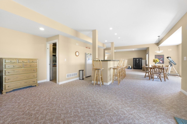 3090 Kellygreen Dr, Angola, IN 46703 - kitchen featuring light carpet, a kitchen breakfast bar, baseboards, open floor plan, and recessed lighting