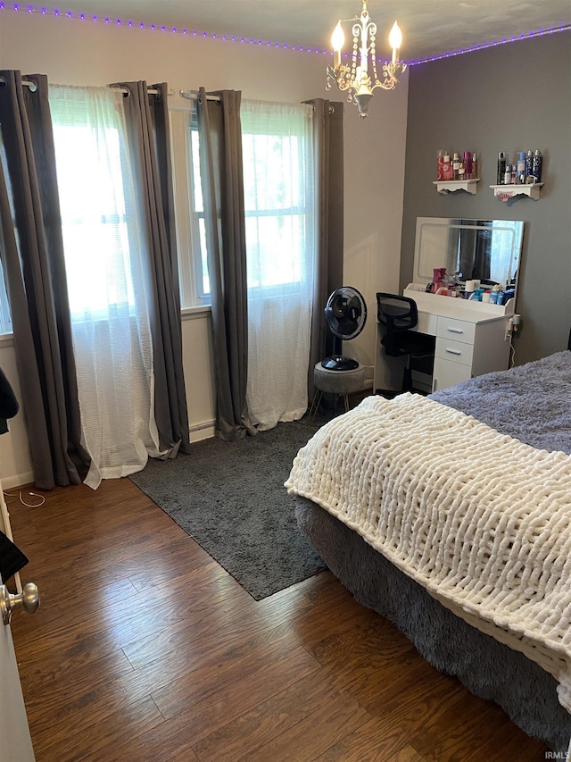 4227 S 0th Rd, Berne, IN 46711 - bedroom featuring wood finished floors and a chandelier