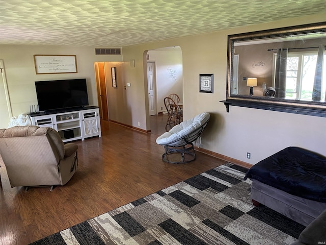 4227 S 0th Rd, Berne, IN 46711 - living room with arched walkways, wood finished floors, and baseboards