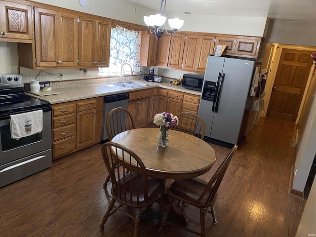 4227 S 0th Rd, Berne, IN 46711 - kitchen featuring stainless steel appliances, a sink, dark wood-type flooring, light countertops, and a chandelier