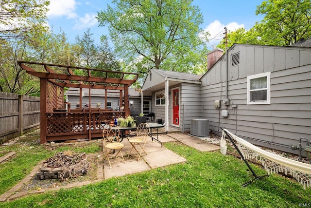 back of house with a fire pit, cooling unit, a pergola, a chimney, and a patio
