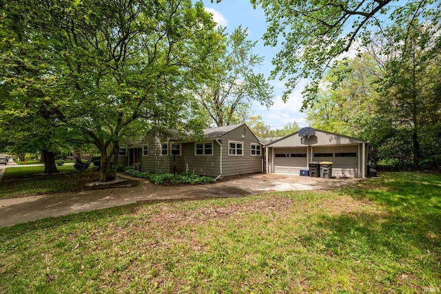 single story home with a garage, an outdoor structure, and a front yard