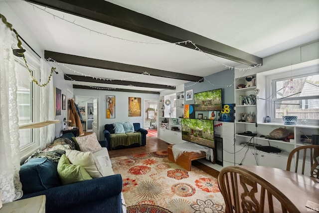 living room featuring beam ceiling and wood finished floors