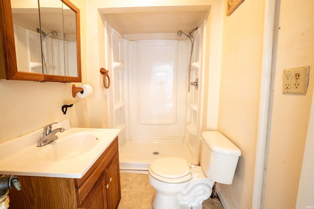 full bath with a shower stall, toilet, vanity, and tile patterned flooring