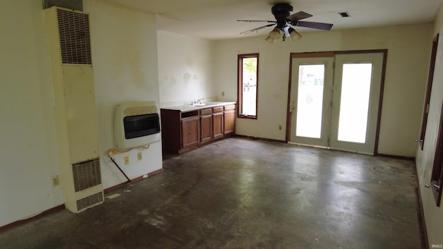 3927 E Driftwood Loop, Monticello, IN 47960 - unfurnished living room featuring a heating unit, heating unit, a sink, concrete floors, and a ceiling fan