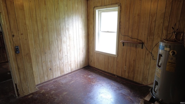 3927 E Driftwood Loop, Monticello, IN 47960 - empty room with electric water heater, wood walls, and baseboards