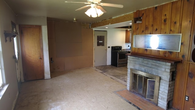 3927 E Driftwood Loop, Monticello, IN 47960 - kitchen with electric range, brown cabinets, a ceiling fan, electric panel, and a brick fireplace