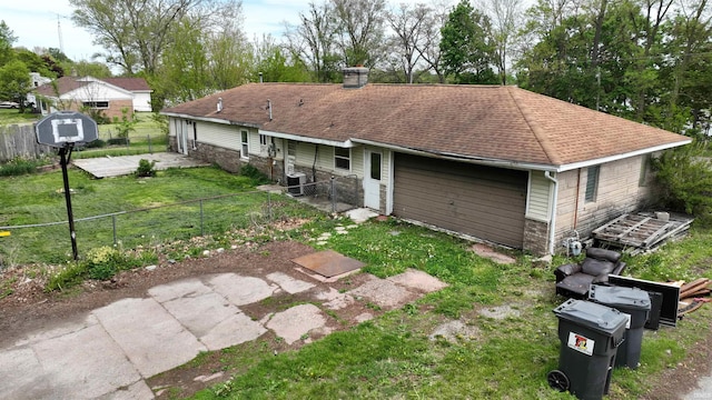 3927 E Driftwood Loop, Monticello, IN 47960 - rear view of property featuring a chimney, central AC, and roof with shingles