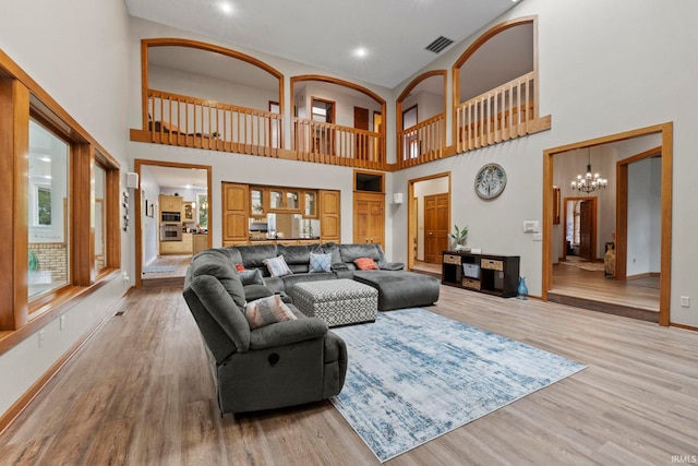 15 Saint Emily Dr, Huntington, IN 46750 - living room with baseboards, light wood-type flooring, a chandelier, a towering ceiling, and recessed lighting