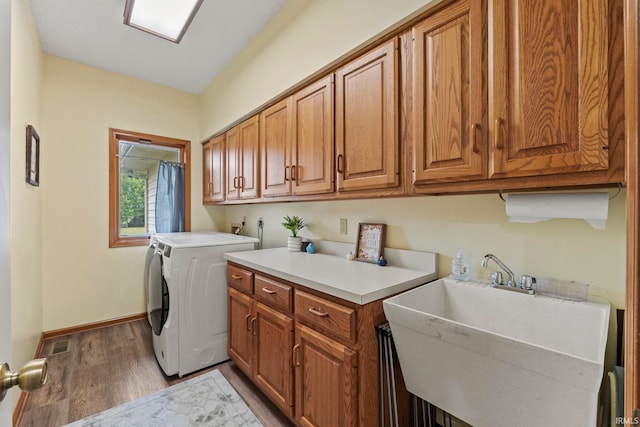 15 Saint Emily Dr, Huntington, IN 46750 - laundry room featuring cabinet space, washer / clothes dryer, wood finished floors, and baseboards