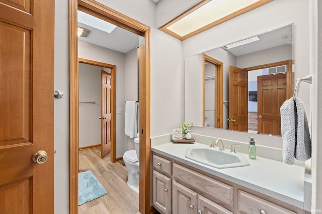 15 Saint Emily Dr, Huntington, IN 46750 - bathroom with wood finished floors, toilet, and vanity