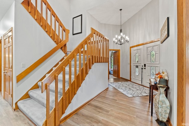15 Saint Emily Dr, Huntington, IN 46750 - foyer with a towering ceiling, stairs, wood finished floors, a chandelier, and baseboards