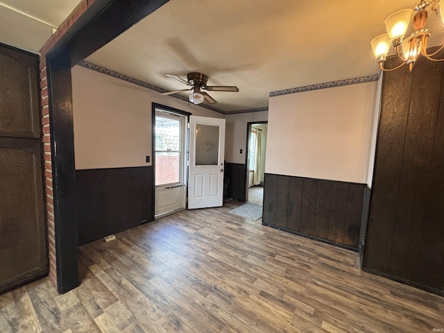 919 Kensington Blvd, Fort Wayne, IN 46805 - empty room with wainscoting, a ceiling fan, a chandelier, and wood finished floors