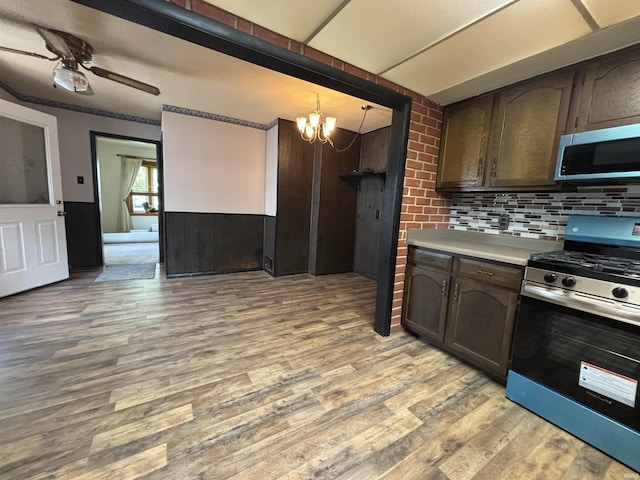 919 Kensington Blvd, Fort Wayne, IN 46805 - kitchen featuring appliances with stainless steel finishes, a chandelier, light wood-style flooring, light countertops, and backsplash