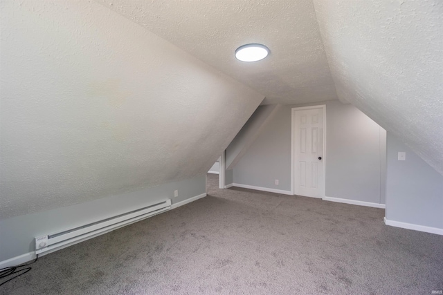 additional living space featuring baseboard heating, a textured ceiling, lofted ceiling, carpet, and baseboards