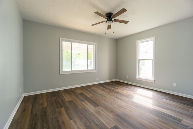 unfurnished room with dark wood-style floors, baseboards, and ceiling fan