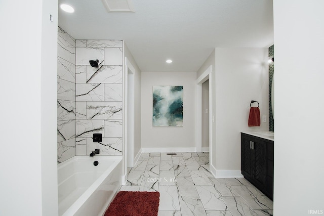 bathroom featuring marble finish flooring, a bath, recessed lighting, baseboards, and vanity