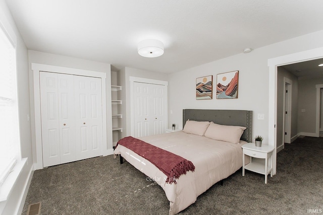 bedroom featuring carpet flooring, two closets, and baseboards