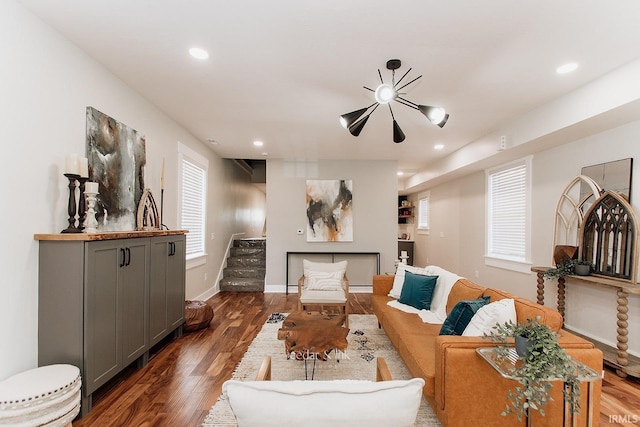 living area with stairway, wood finished floors, recessed lighting, and baseboards