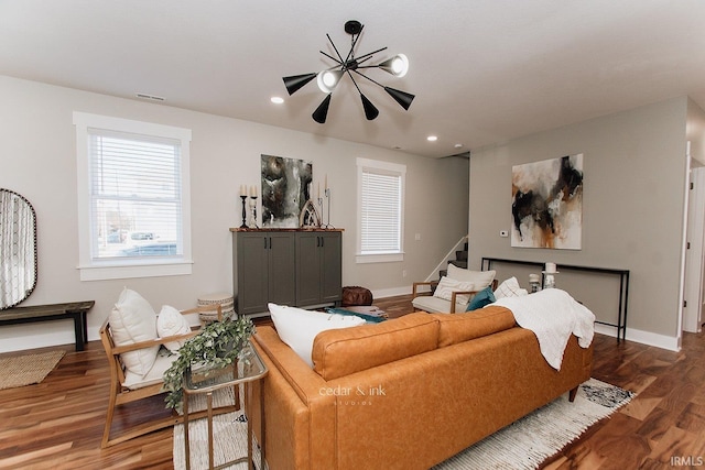 living room featuring baseboards, stairs, wood finished floors, and recessed lighting