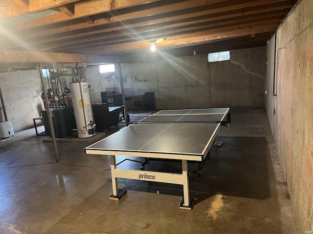6701 Bellefield Dr, Fort Wayne, IN 46835 - playroom with unfinished concrete flooring, gas water heater, a heating unit, and plenty of natural light
