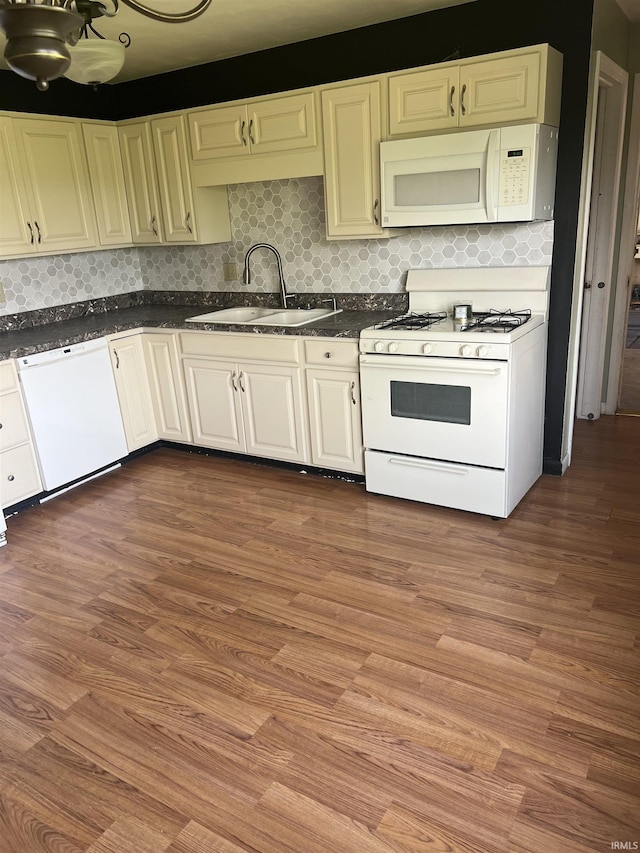 6701 Bellefield Dr, Fort Wayne, IN 46835 - kitchen featuring white appliances, a sink, and wood finished floors